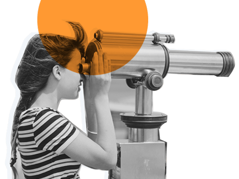 girl looking through a telescope